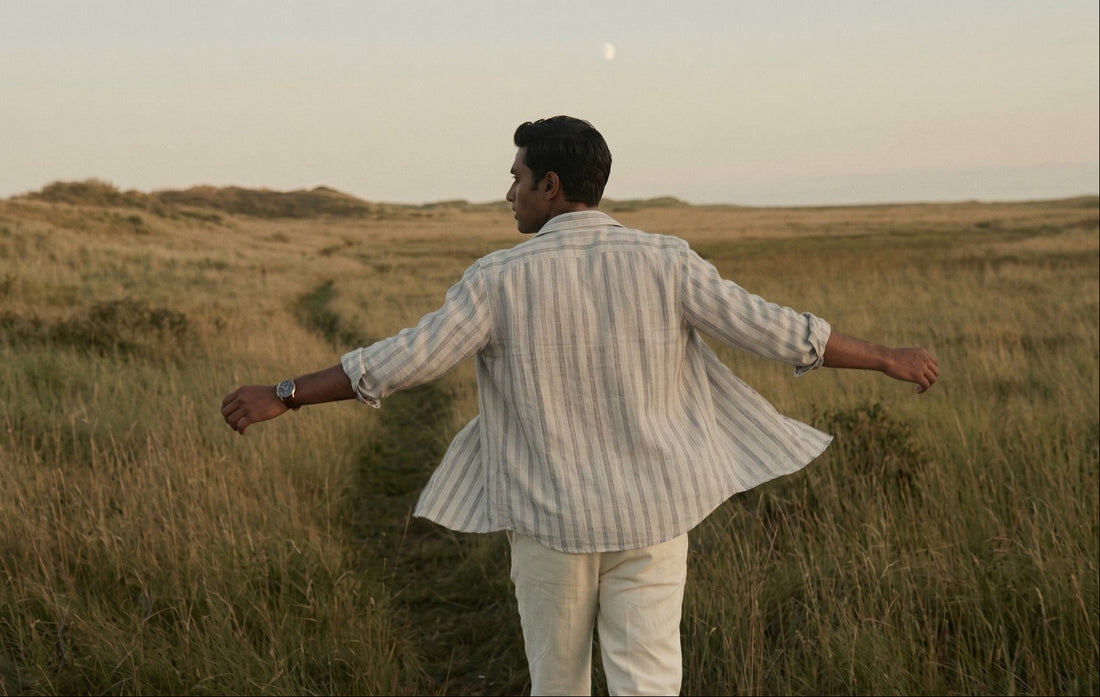 indian man wearing a tyra linen 100% pure linen shirt and in the field with wind hustling 