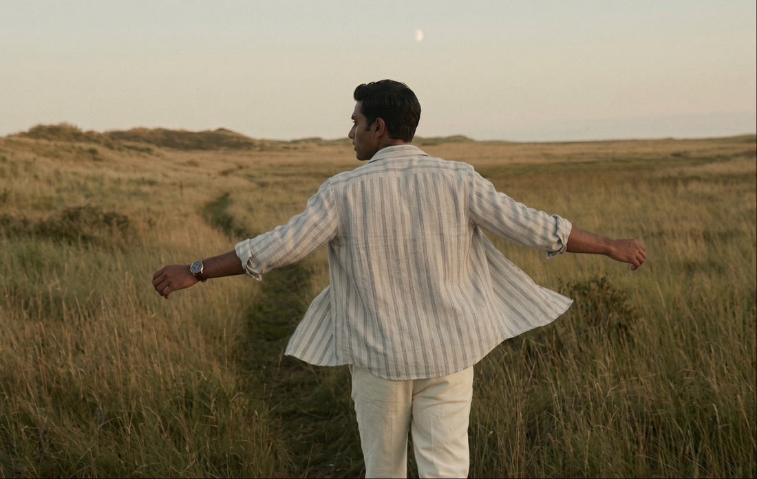 indian man wearing a tyra linen 100% pure linen shirt and in the field with wind hustling 