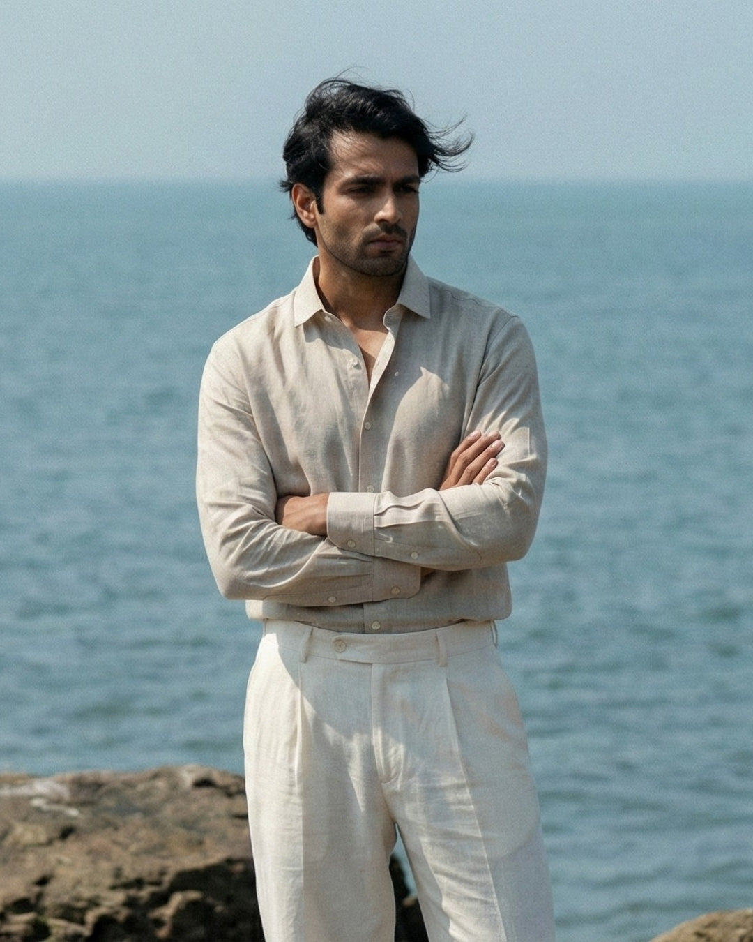 Premium light blue linen shirt for men worn in a natural outdoor setting, highlighting breathable fabric, relaxed fit, and contemporary work-casual menswear style.