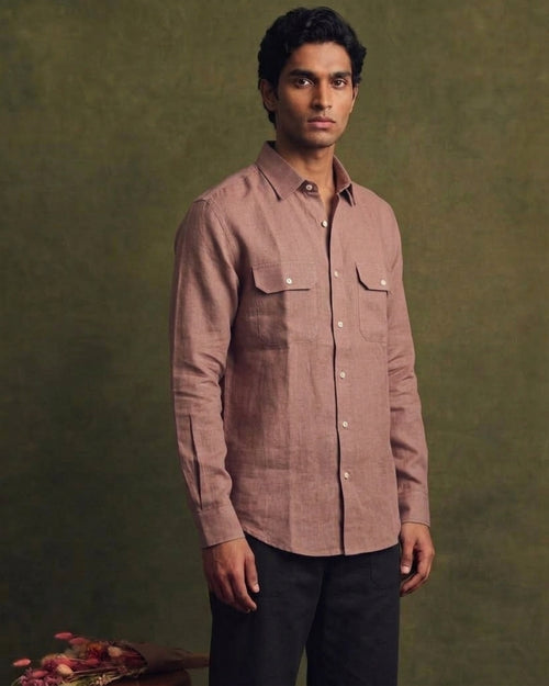 Dusty brown linen shirt with a classic collar, full button-front closure, long sleeves, and two flap chest pockets, styled with black trousers.