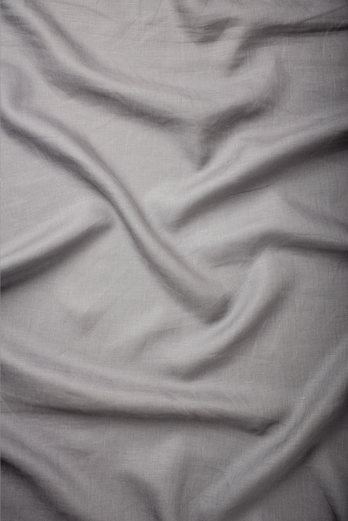 Light grey premium linen fabric with a fine weave and natural creasing, perfect for modern men’s shirts and versatile everyday wear