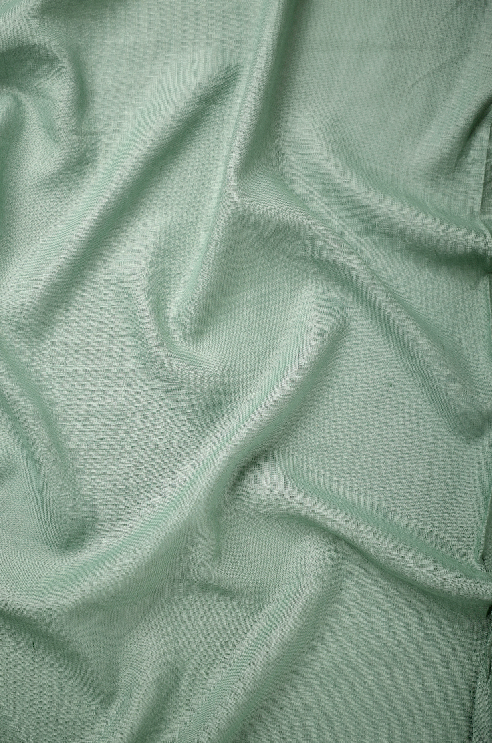 Premium sage green linen fabric with a smooth weave and elegant natural folds, ideal for breathable men’s shirts and smart casual wear