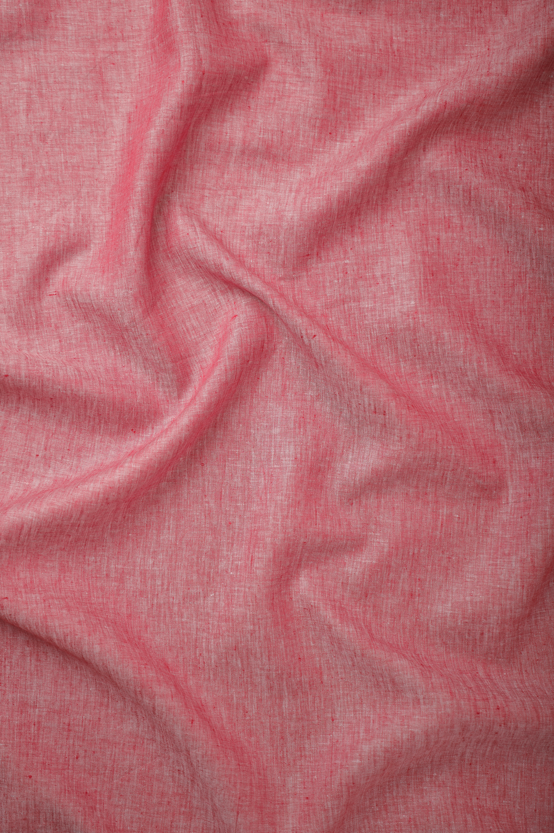 Rose red linen fabric with a soft washed finish, highlighting natural fiber texture, relaxed drape, and breathable lightweight construction.”